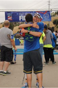 After the Laguna Hills Half Marathon, Greg gives Jeff, from OC Rescue Mission a big hug.